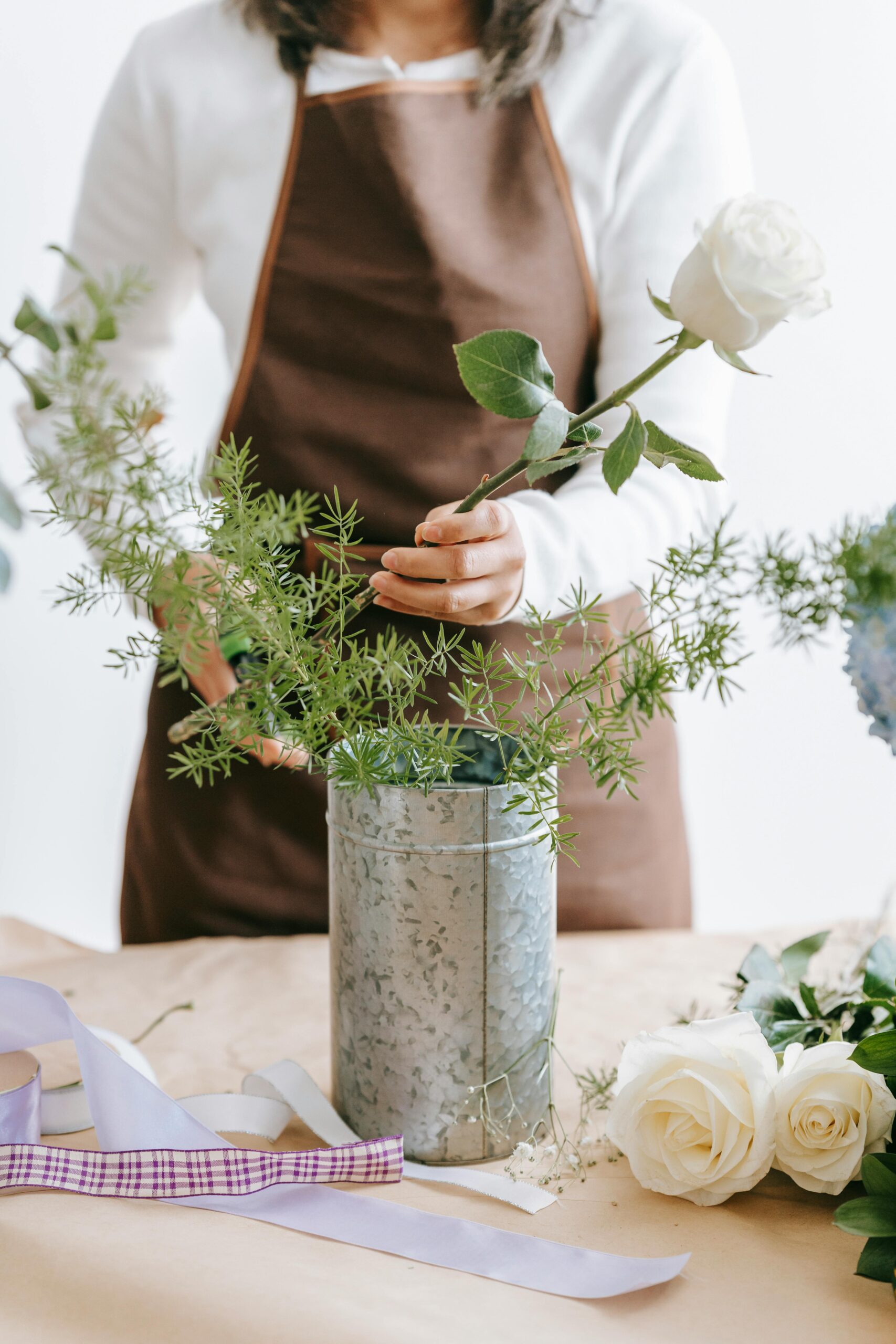 Florist arange a vase. Small business owner searching for advice on lead generation and marketing systems